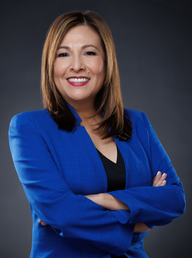 Dr. Madeleine F. Wallace, the CEO of Windrose Vision seen in blue and black color combination formal office outfit